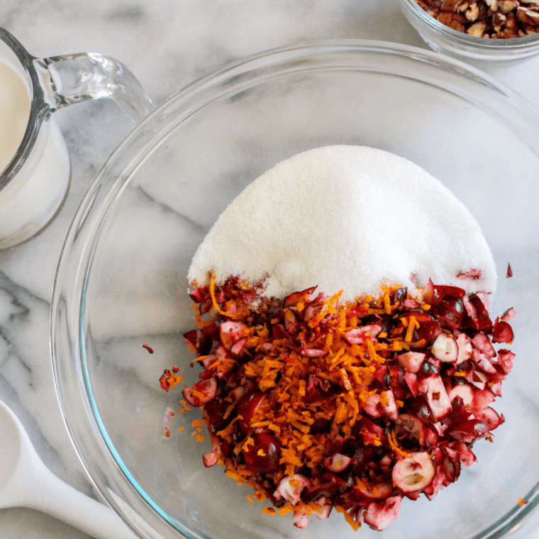 Chopped cranberries, pecans and orange zest tossed in a bowl
