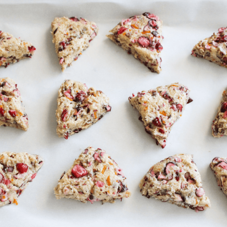 Cranberry orange scone wedges on parchment in an air fryer basket