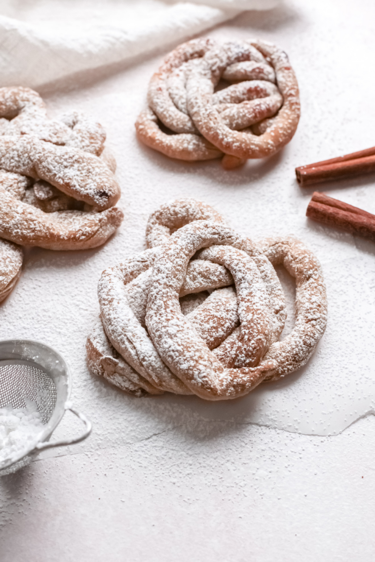 Homemade funnel cakes cooling on parchment paper after air frying