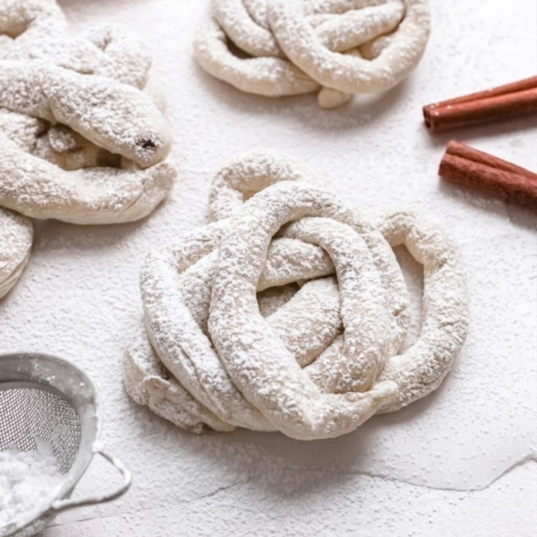 Crispy homemade funnel cakes made in the air fryer topped with powdered sugar