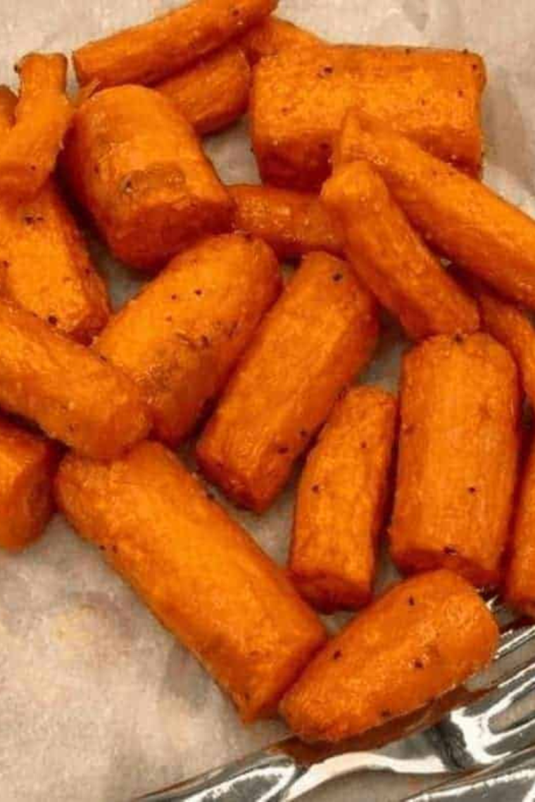 "Garnishing air fryer garlic roasted carrots with fresh parsley before serving"