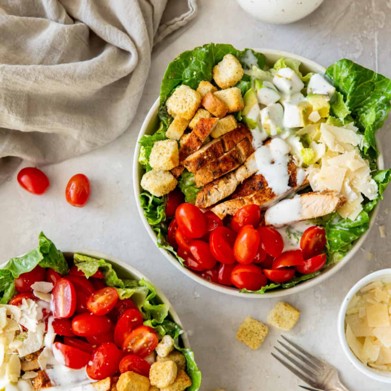 Slicing grilled chicken into strips for the Caesar salad.