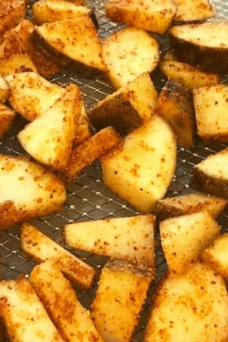 Golden air fryer potato cubes coated in maple BBQ sauce, crispy on the outside, tender inside, served on a plate.