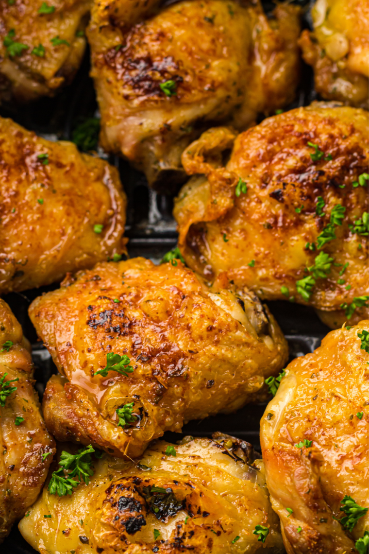 Instant-read thermometer reading 178°F inserted into a bone-in pesto chicken thigh