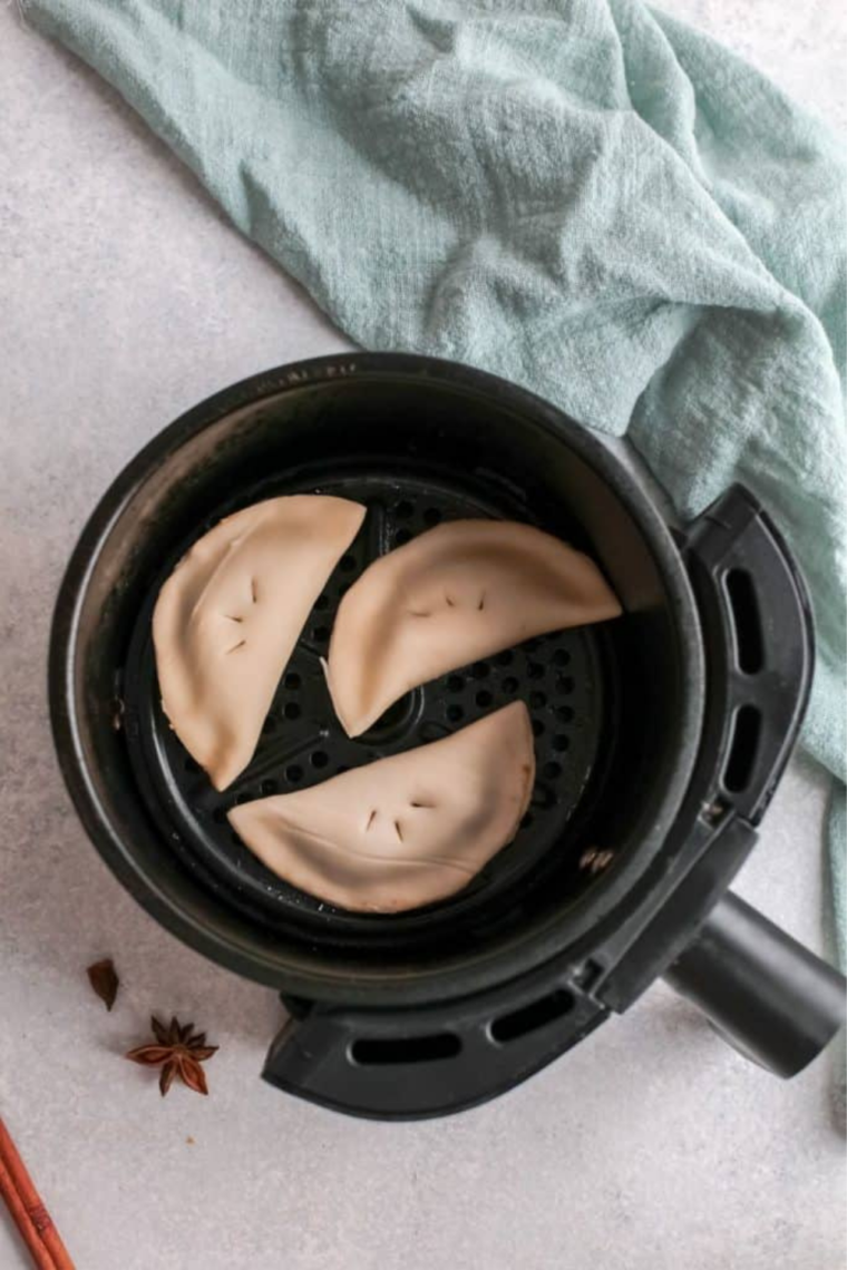 Air frying pumpkin hand pies in batches at 350°F until golden brown, sprayed lightly with butter cooking spray for a flaky finish.