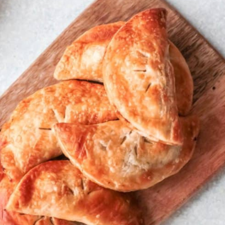 Air Fryer Pumpkin Hand Pies with golden crusts and spiced pumpkin filling, served on a plate.