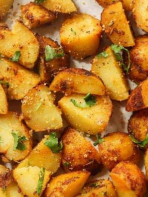 Crispy air fryer ranch potatoes in a white bowl with golden brown edges and chopped parsley