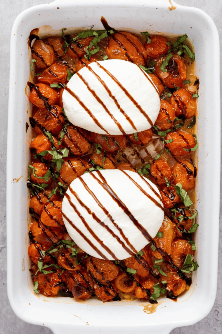 Roasted cherry tomatoes topped with fresh mozzarella and basil