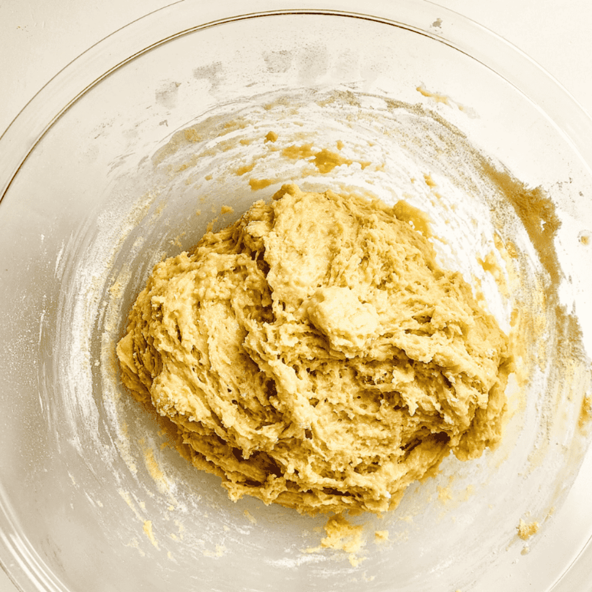 Combine warm milk, sugar, yeast, eggs, butter, and flour in a bowl to create dough that is slightly sticky.