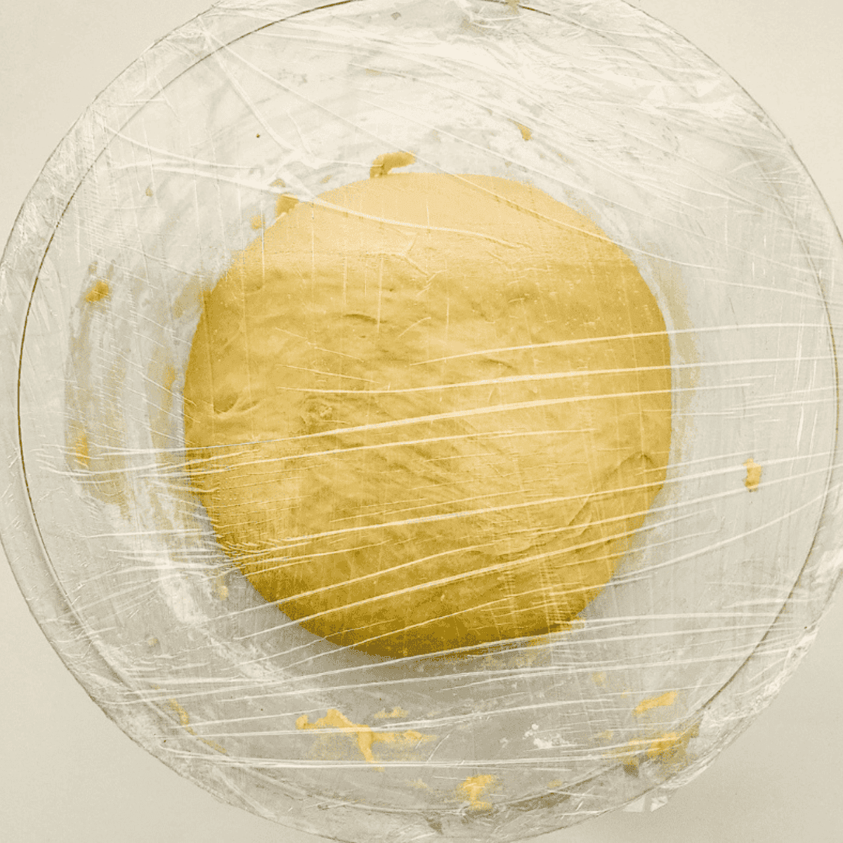 Working dough that has rested on a floured surface, rolling and cutting into small squares or rectangles.