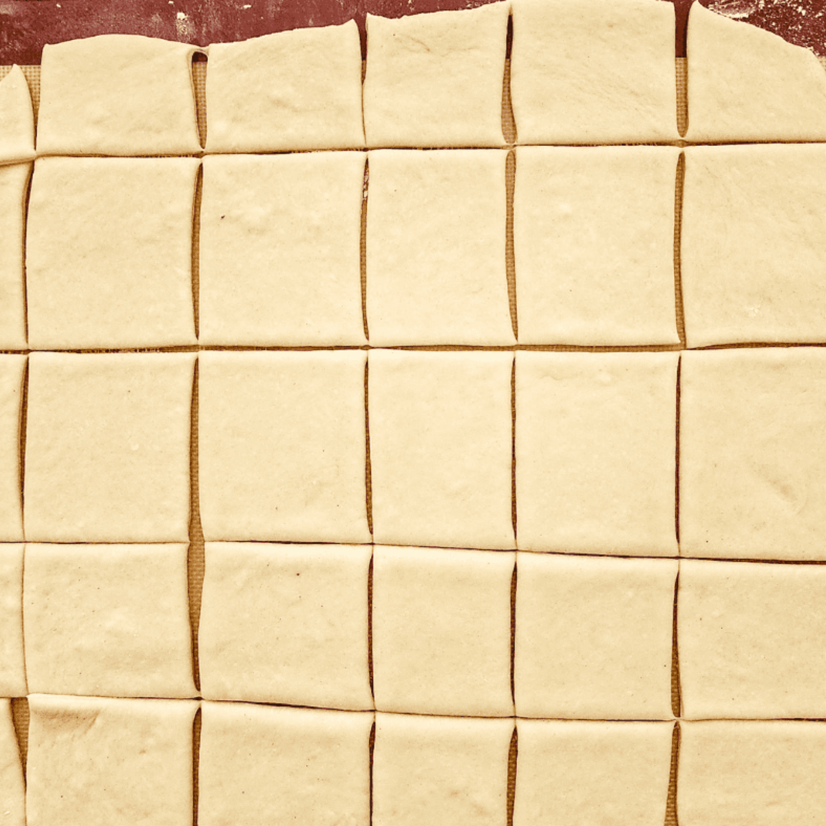 Beignets formed within an air fryer basket, glazed with egg wash or butter, ready to air fry until browned.