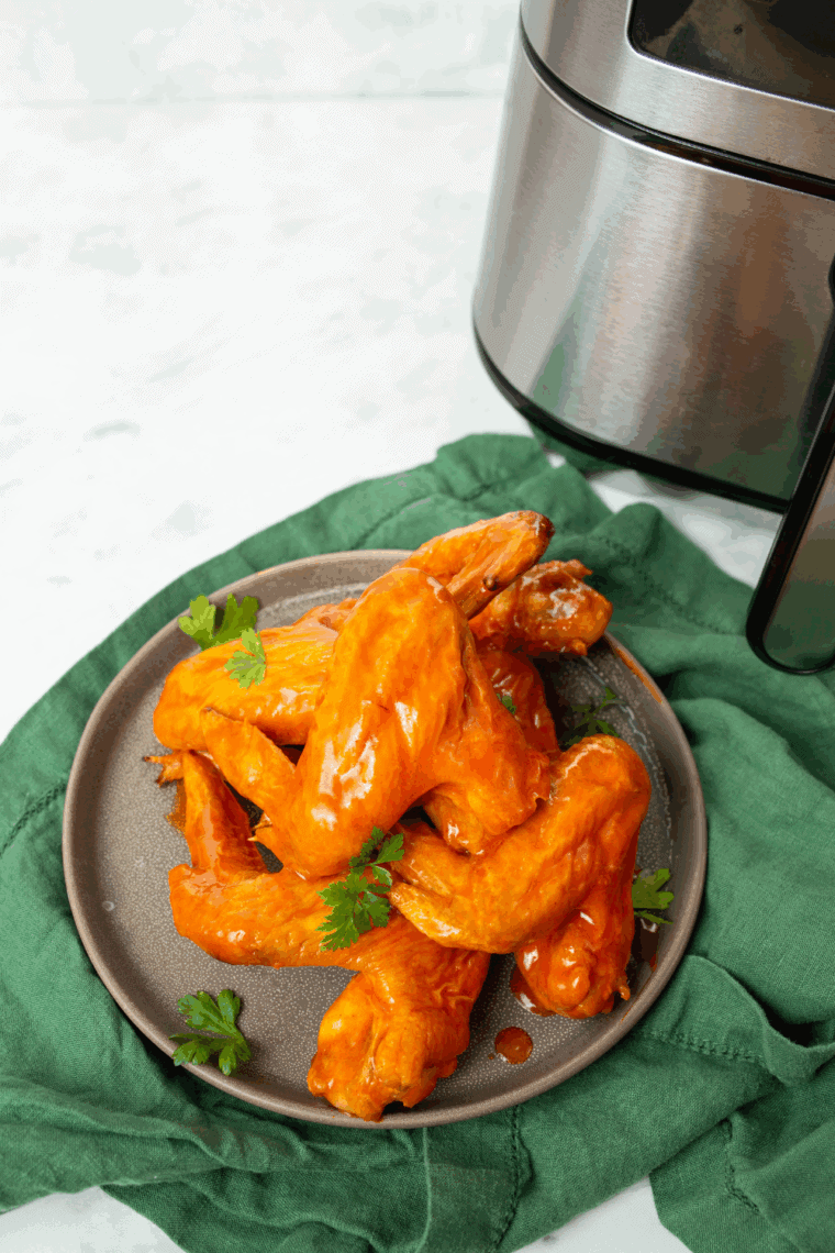 Crispy hot buffalo chicken wings coated in spicy sauce served with ranch dressing and celery sticks.