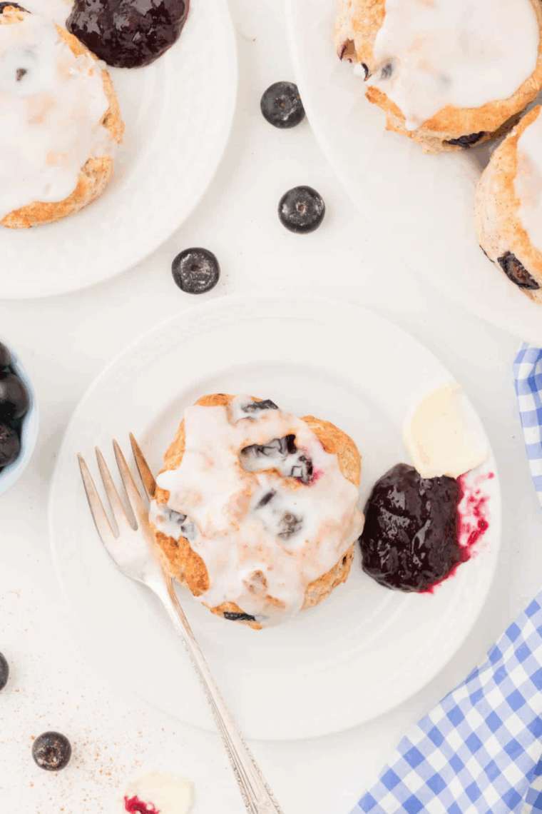 Golden-brown Air Fryer Blueberry Biscuits with juicy blueberries, fresh from the air fryer, served on a plate ready to eat.