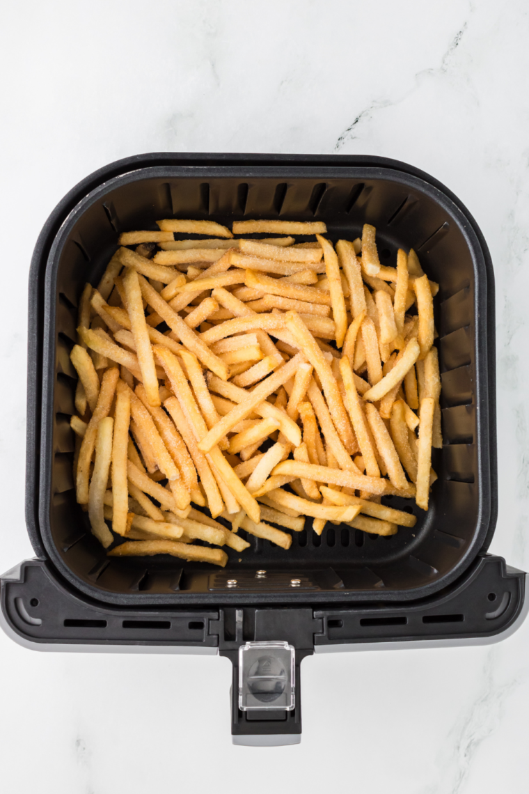 Place the frozen French fries into the air fryer basket, in a single layer.