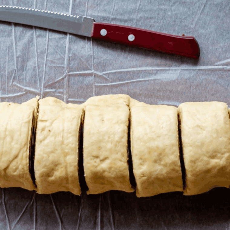 Using a sharp knife cut the cinnamon rolls into pieces.