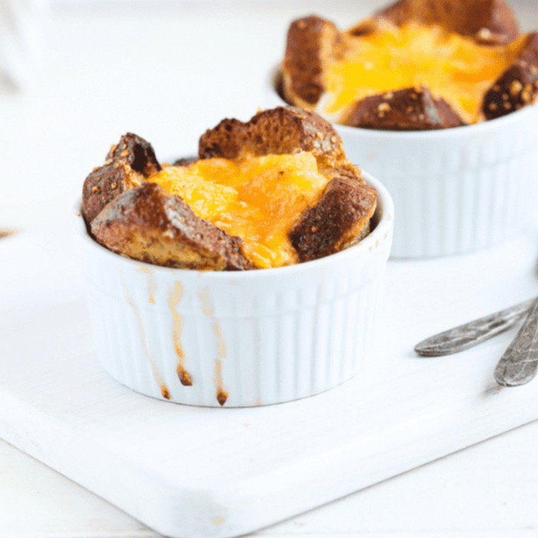 Air fryer French toast mug golden and fluffy in a small ramekin topped with syrup