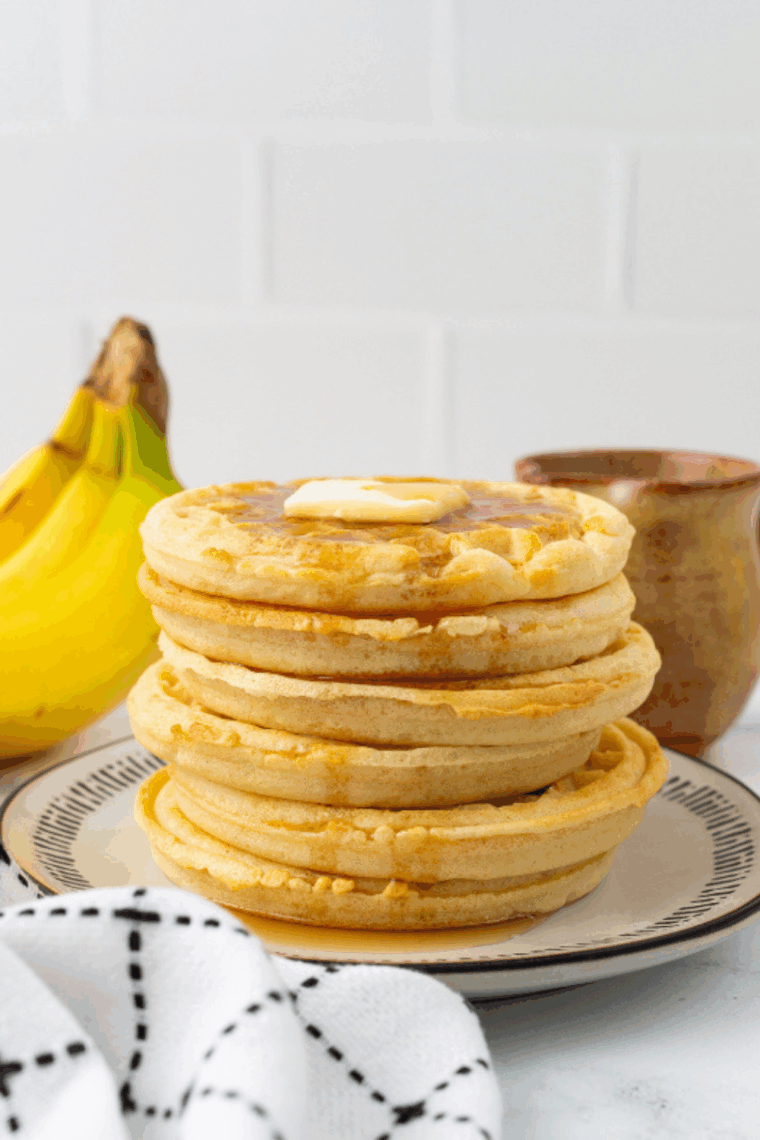 Crispy frozen waffles cooking in an air fryer basket, golden and ready to serve.