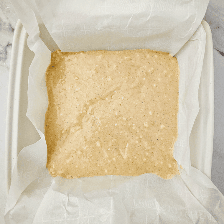 Spread half of the batter evenly into the prepared pan. Layer the chopped apples evenly on top of the batter.
