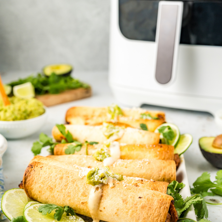 Crispy air fryer beef and bean taquitos filled with seasoned ground beef, refried beans, and melted cheese served with salsa