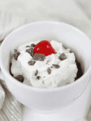 Warm fudgy brownie in a mug cooked in air fryer, rich chocolate single-serve dessert with gooey center served for quick treat or snack