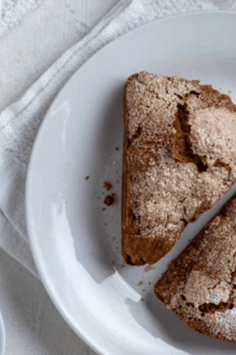 Golden gingerbread scones fresh from the air fryer, brushed with egg white and sprinkled with sparkling sugar, ready to serve.