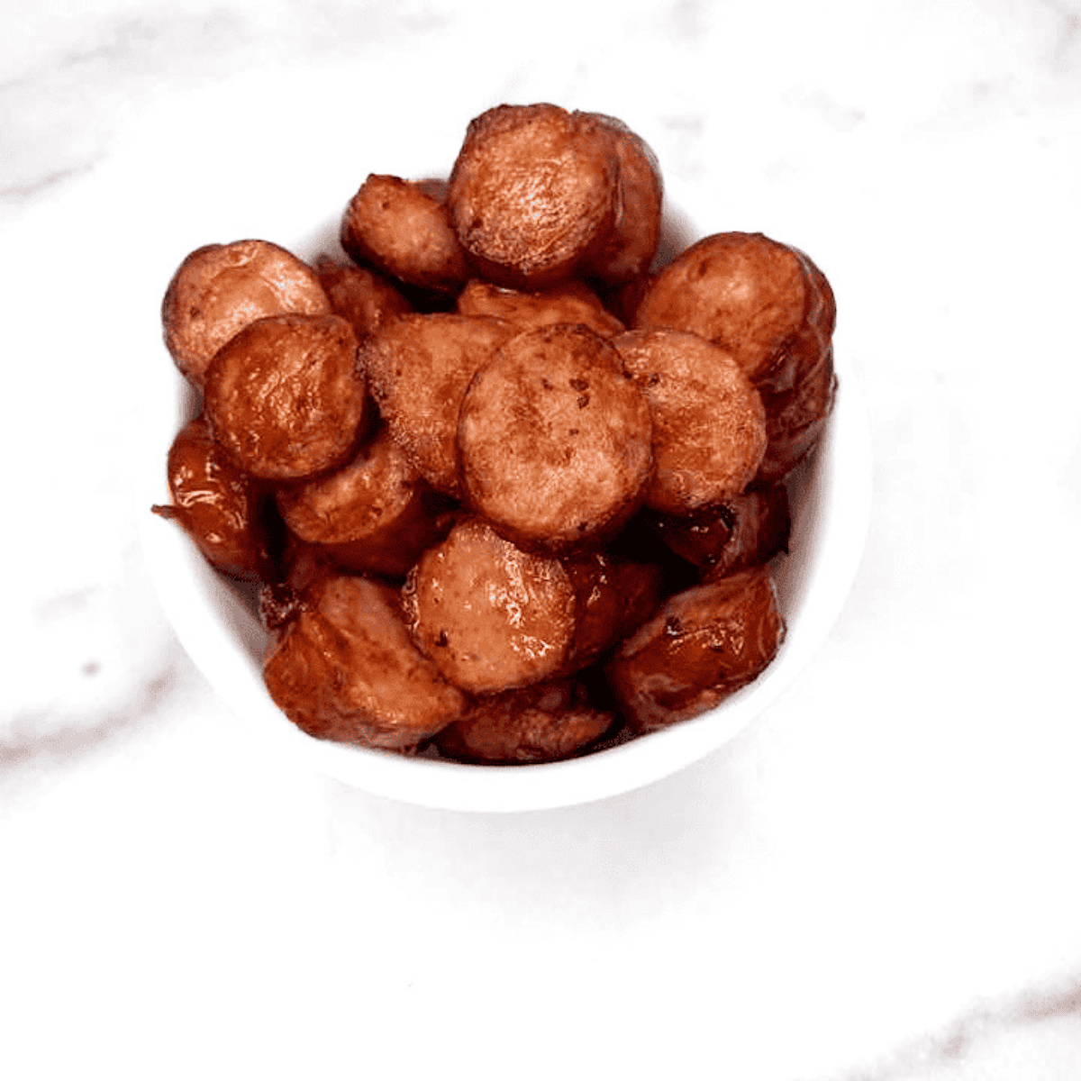 Golden brown air fryer kielbasa slices cooked to crispy perfection.