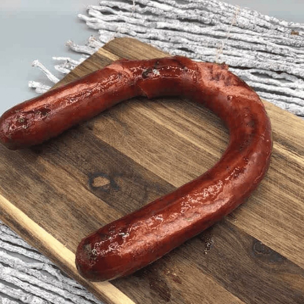 Sliced air fryer kielbasa cooked to golden brown perfection on a serving plate.