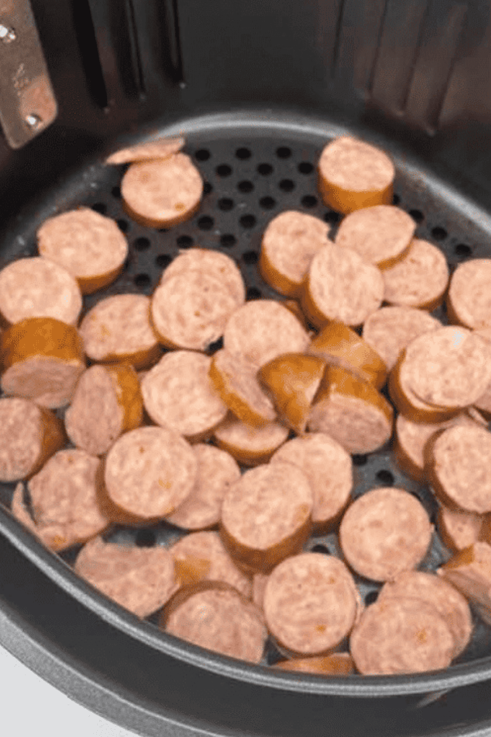 Sliced air fryer kielbasa cooked to golden brown and served on a plate.
