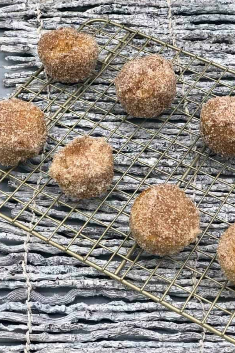 Plate of Easy Air Fryer Pumpkin Spice Donut Holes on cooling rack.