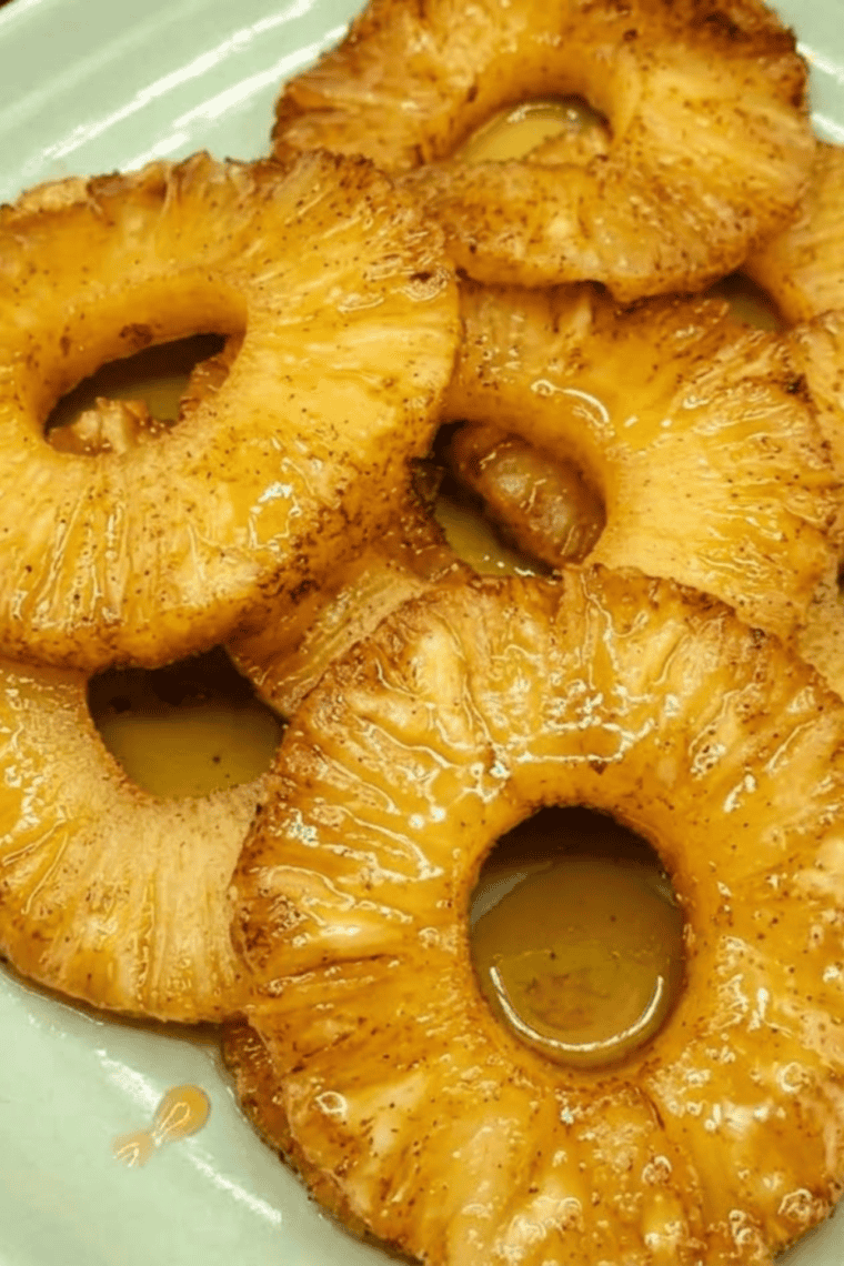 Caramelized rum-soaked pineapple slices cooked in an air fryer, golden and juicy.