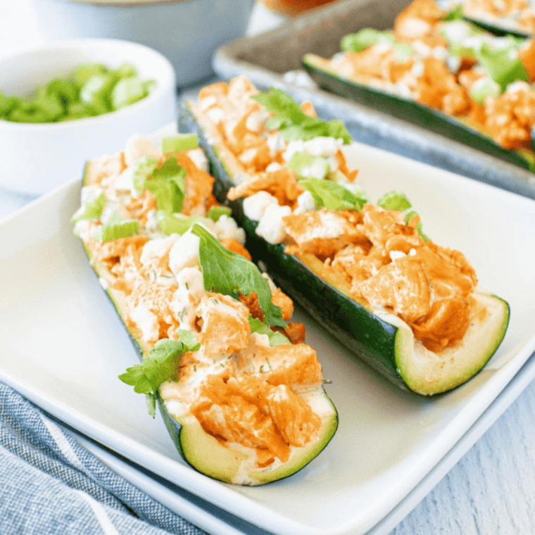 Air Fryer Zucchini Boats filled with seasoned ground turkey, topped with melted cheese and fresh herbs.