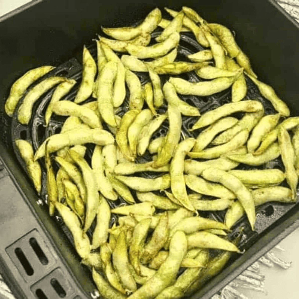 Cooked Copycat Benihana Edamame Recipe in the air fryer basket.