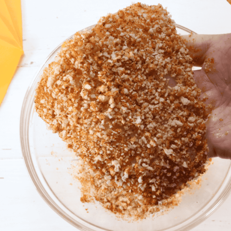 Using paper towels to remove moisture from fish, then dipping it into egg and breadcrumb mixture on both sides.