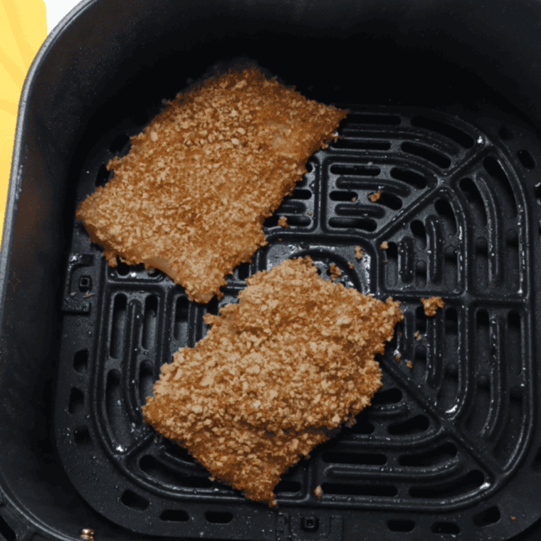 Spraying the air fryer basket with cooking spray, placing breaded fish in a single layer, and setting the air fryer to 350°F for cooking.