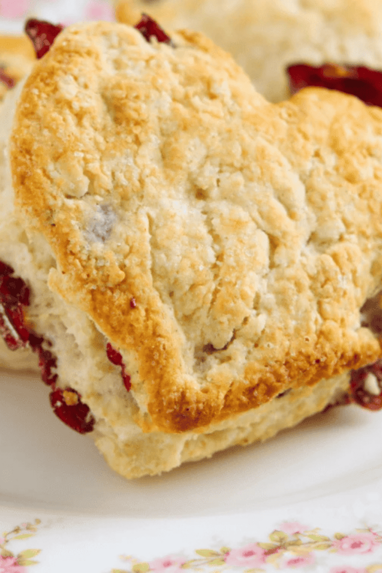 Freshly baked Air Fryer Cherry Scones with golden tops and sweet cherry pieces on a plate.