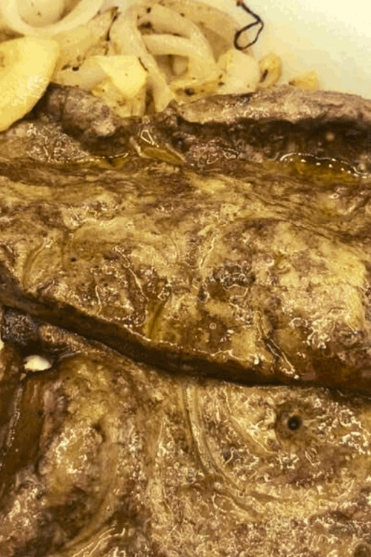Air fryer liver and onions on a plate, tender slices with golden caramelized onions, ready to serve.