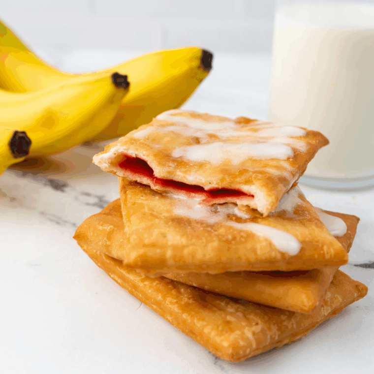Perfectly flaky, golden Air Fryer Toaster Strudel on a plate, drizzled with frosting.