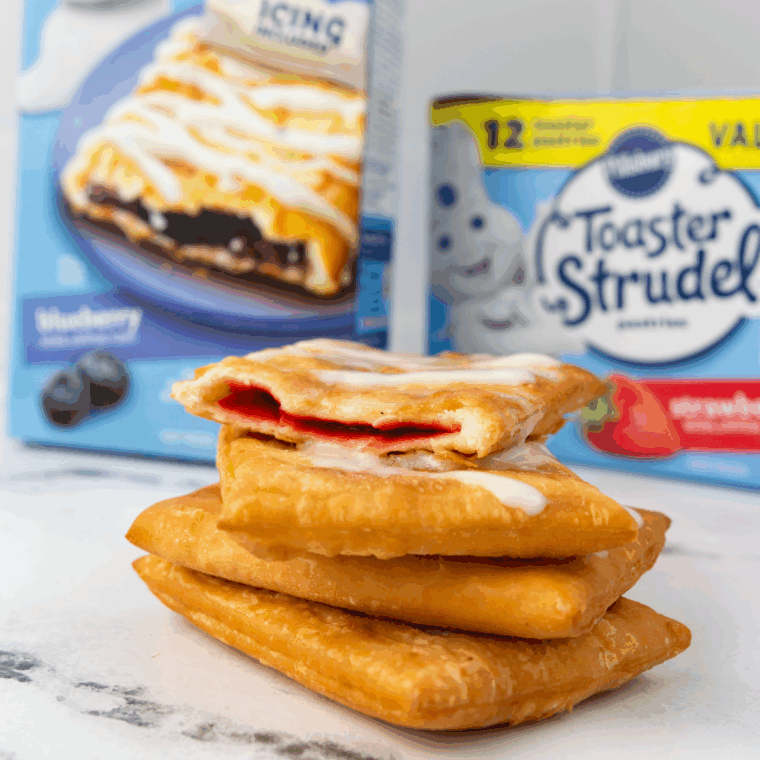 Perfectly flaky, golden Air Fryer Toaster Strudel on a plate, drizzled with frosting.