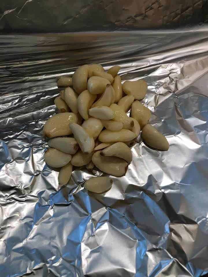 process shot: garlic cloves on foil to make roast garlic in air fryer