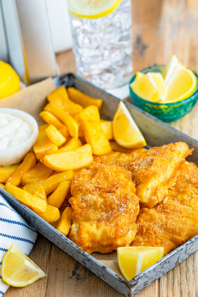 Crispy air fryer beer battered cod on a plate with fries and tartar sauce