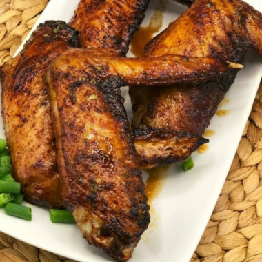 crispy air fryer honey roasted turkey wings glazed with honey and herbs on a plate