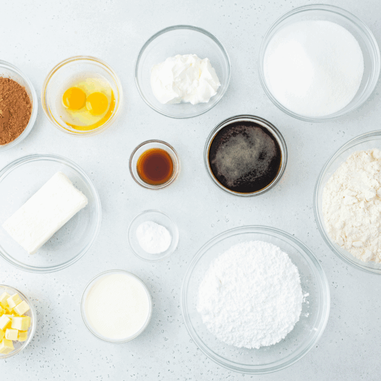 Ingredients for air fryer one bowl chocolate cake including flour, cocoa powder, sugar, eggs, milk, and oil