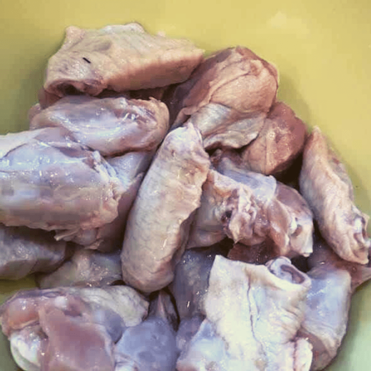 Raw chicken wings in a bowl ready for seasoning