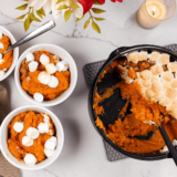 "Air Fryer Sweet Potato Casserole with a golden, crispy marshmallow and pecan topping in a baking dish."