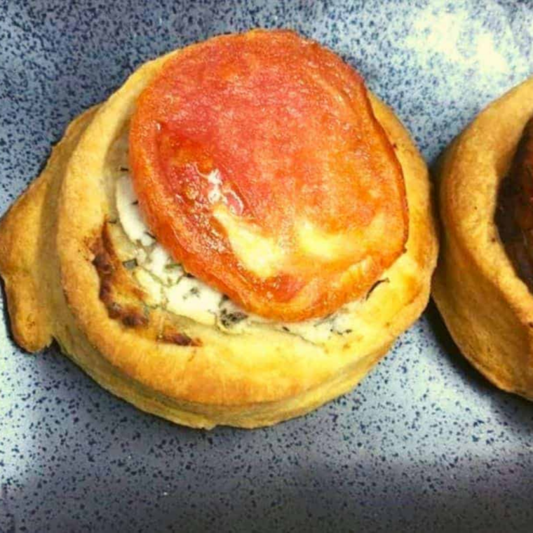 Air fryer roasted tomato goat cheese tart with golden crust and melted cheese filling