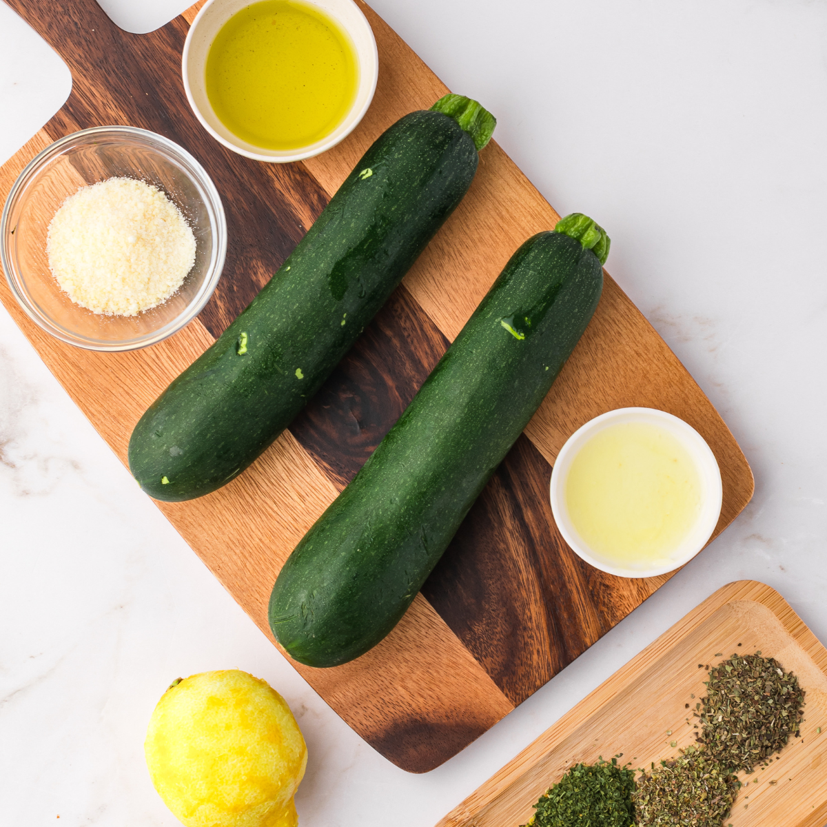 Ingredients needed Air Fryer Zucchini Foil Packets on cutting board.