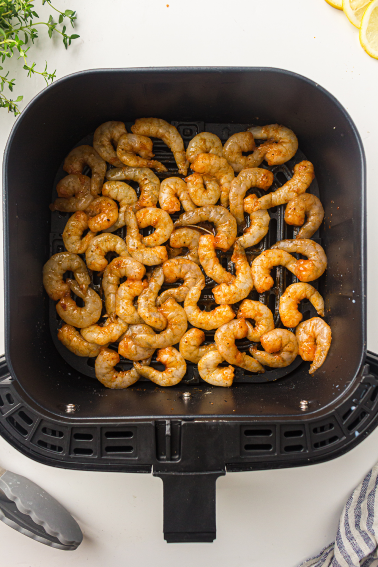 Air fryer preheating to 400 degrees Fahrenheit before cooking shrimp for even roasting.