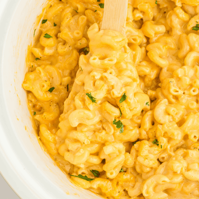 Bowl of creamy Instant Pot copycat Kraft mac and cheese, ready to serve, with smooth cheesy sauce coating tender elbow macaroni.