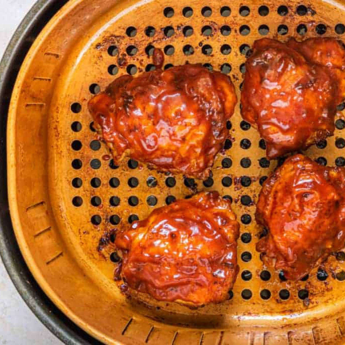 overhead: bbq chicken thighs in air fryer basket