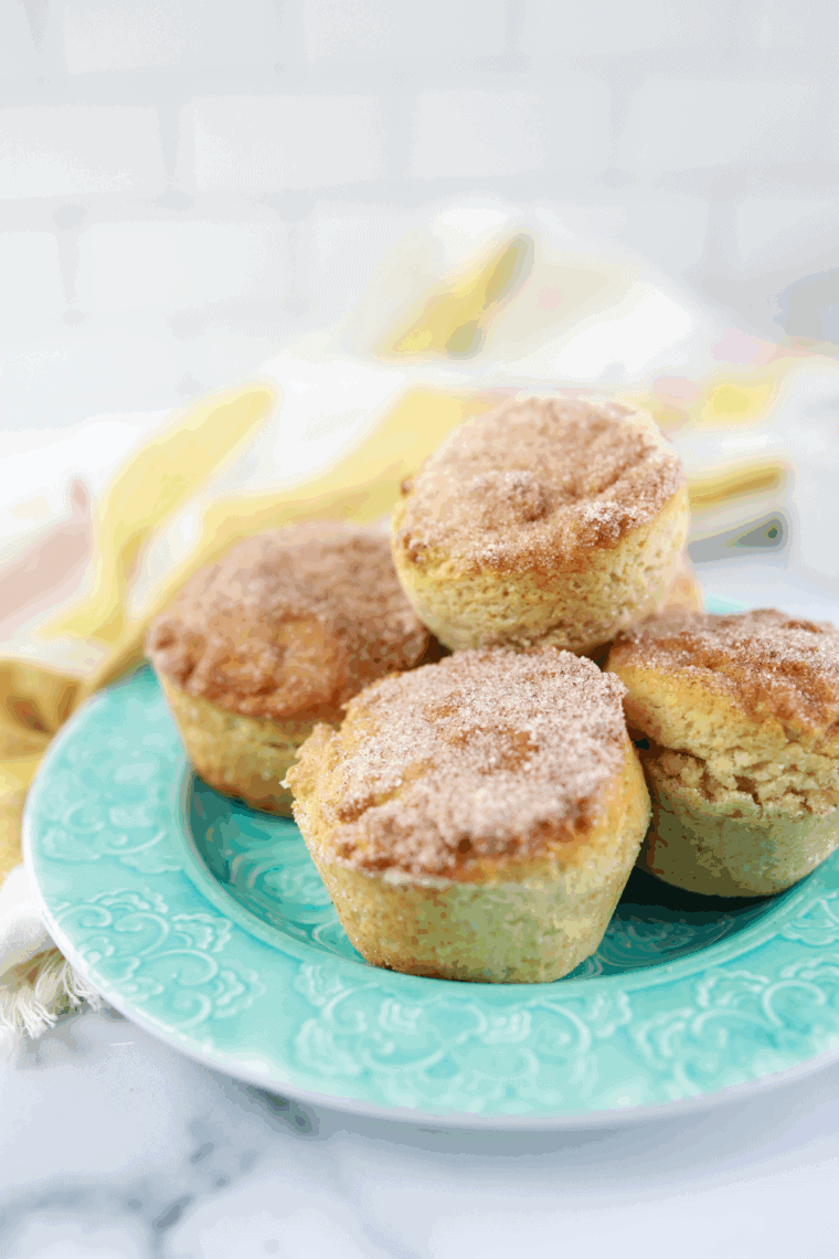 Golden air fryer cinnamon sugar donut muffins coated in sweet cinnamon-sugar